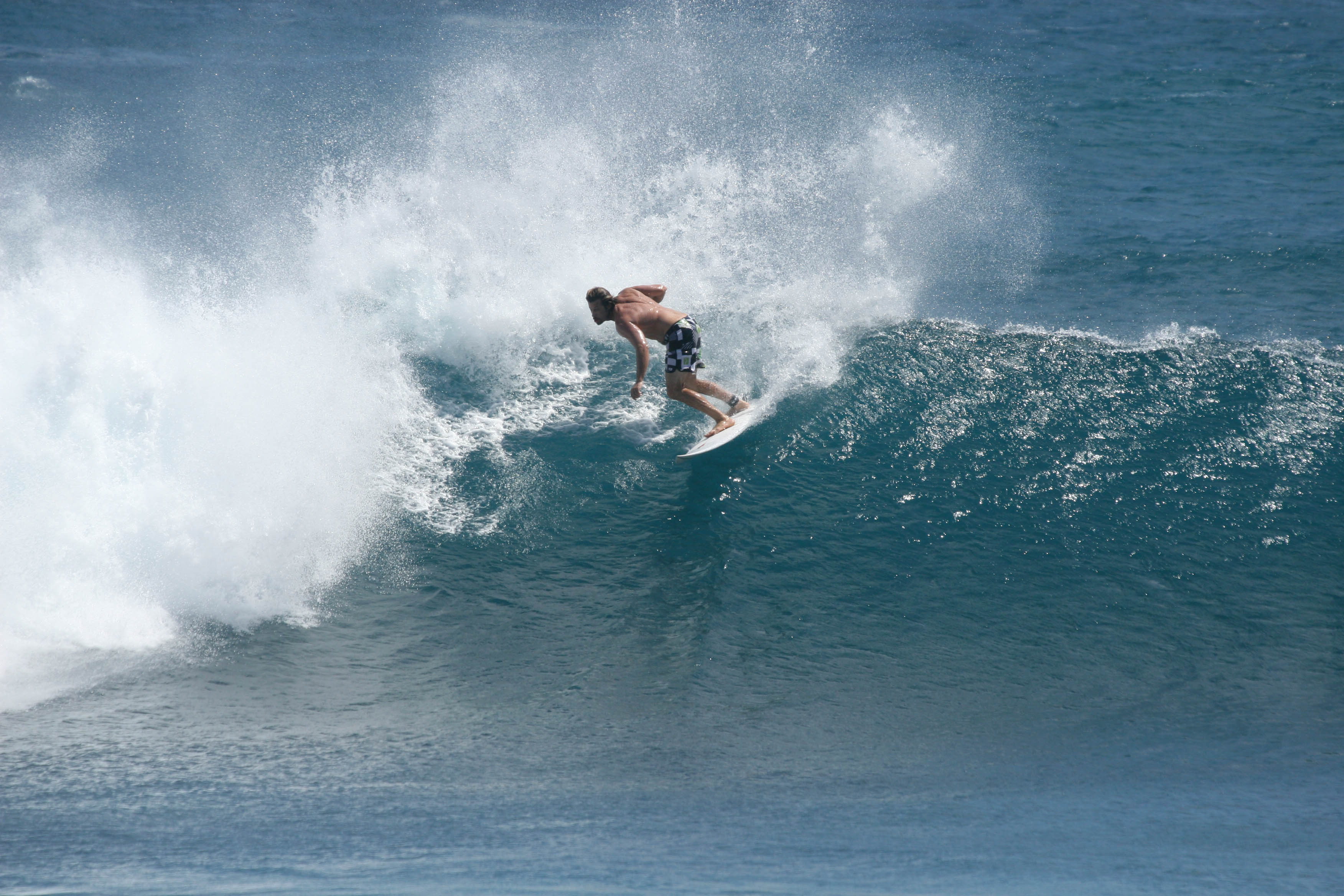 A surfer turning on a breaking wave at Mawi, Lombok